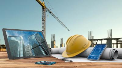 Blueprints,,Safety,Helmet,And,Computer,In,Construction,Site